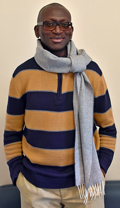 Man wearing a sweater and wool scarf