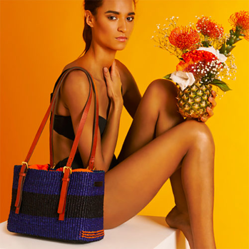 Model sitting with an AAKS Vea Square Shoulder Bag